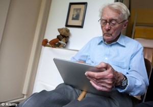 Old man reading iPad tablet computer
